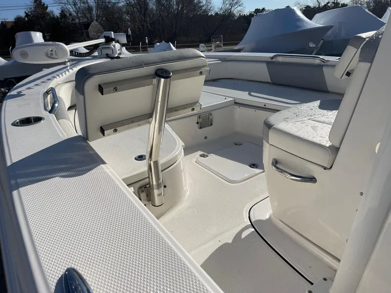 Slide: The Image of 2022 Robalo 226 Cayman boat interior with seating and storage compartments. - 13