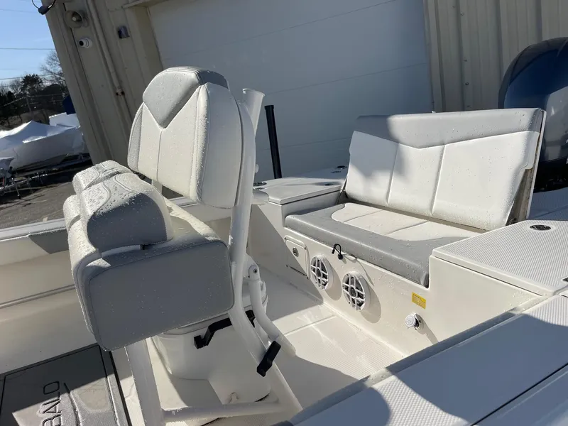 Slide: The Image of 2022 Robalo 226 Cayman boat interior with cushioned seating and speakers. - 15