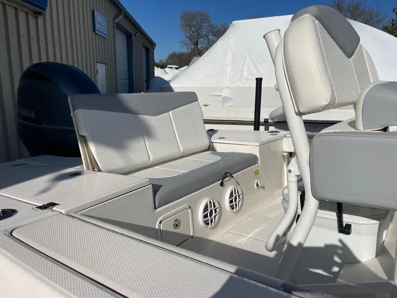Slide: The Image of 2022 Robalo 226 Cayman boat interior with seating and Yamaha engine. - 17