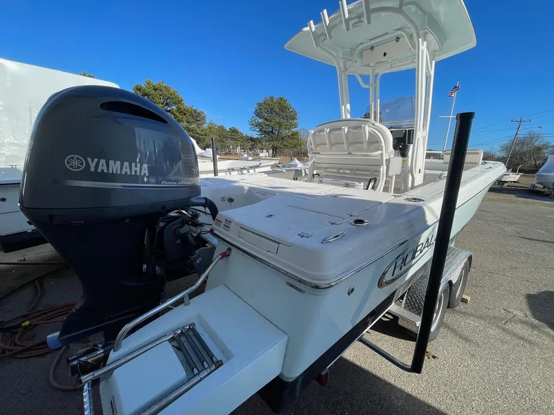 Slide: The Image of 2022 Robalo 226 Cayman boat with Yamaha engine, parked on a trailer. - 3