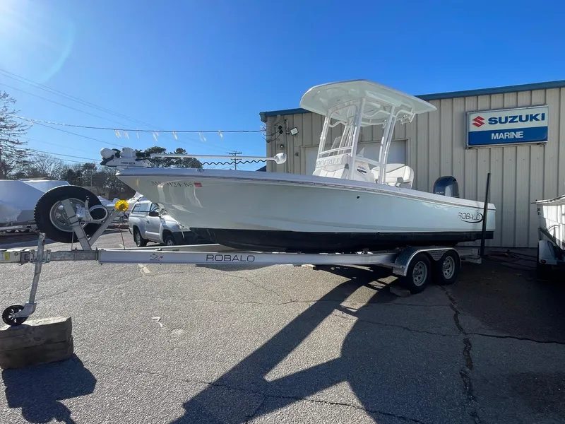 Slide: The Image of 2022 Robalo 226 Cayman boat on trailer at Suzuki Marine dealership. - 5