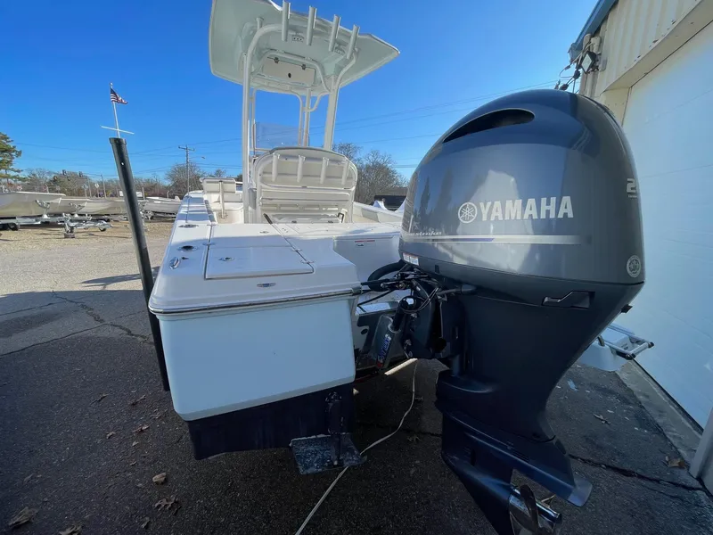 Slide: The Image of 2022 Robalo 226 Cayman boat with Yamaha outboard motor, docked outdoors. - 6
