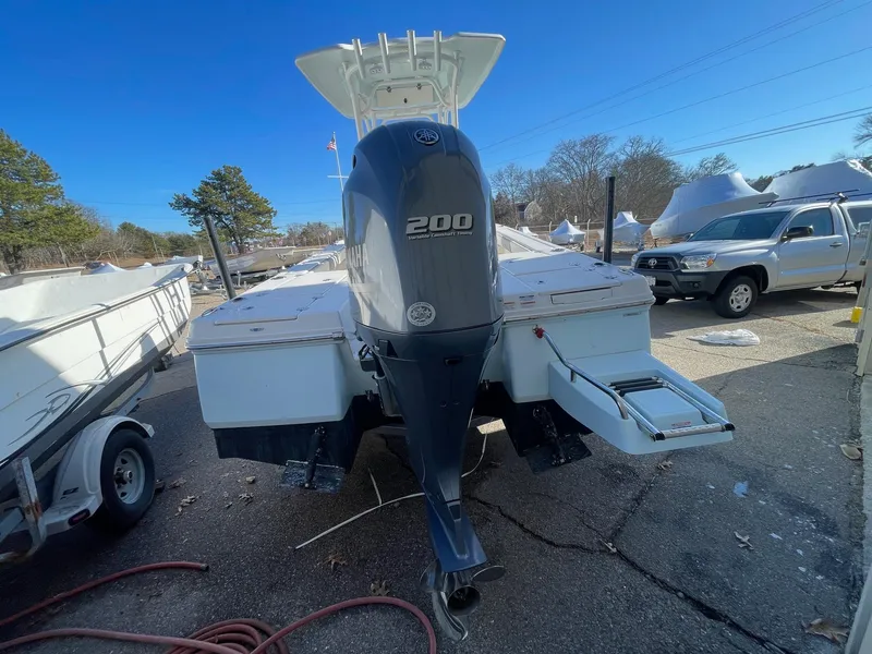 Slide: The Image of 2022 Robalo 226 Cayman boat with 200 HP engine, parked outdoors. - 8