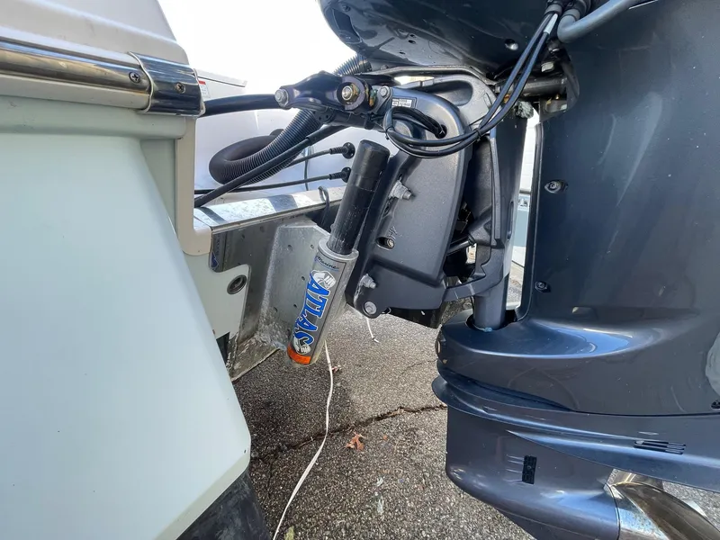 Slide: The Image of 2022 Robalo 226 Cayman boat engine close-up, showcasing motor and hydraulic components. - 9