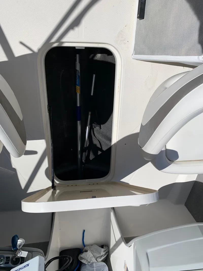 Slide: The Image of Open storage compartment on a 2009 Bayliner 205 boat interior. - 11