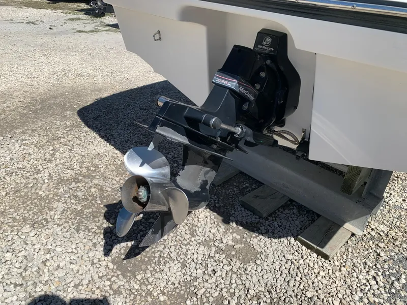 Slide: The Image of 2009 Bayliner 205 boat with Mercury MerCruiser outdrive on gravel surface. - 12