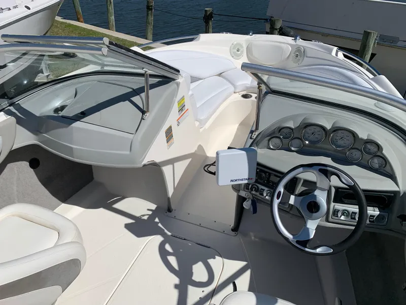 Slide: The Image of 2009 Bayliner 205 boat interior with steering wheel and dashboard controls. - 2