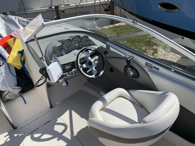 Slide: The Image of 2009 Bayliner 205 boat cockpit with steering wheel and dashboard controls. - 4