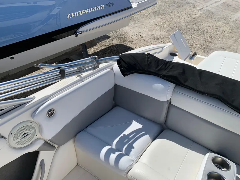 Slide: The Image of Interior of a 2009 Bayliner 205 boat with white seating and cup holders. - 7