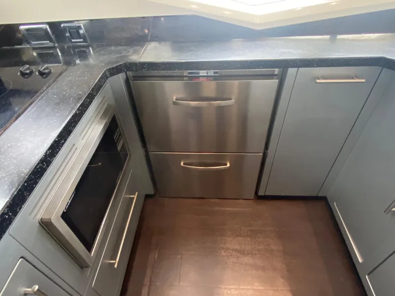 Slide: The Image of Modern kitchen area in a 2010 Marquis 500 Sport Bridge yacht with stainless steel appliances. - 12