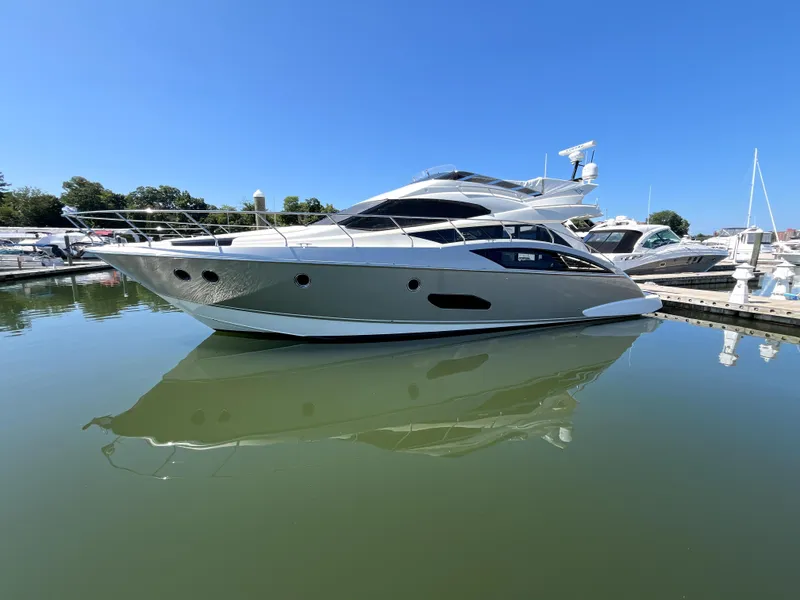 Slide: The Image of 2010 Marquis 500 Sport Bridge yacht docked in a marina under clear blue skies. - 14