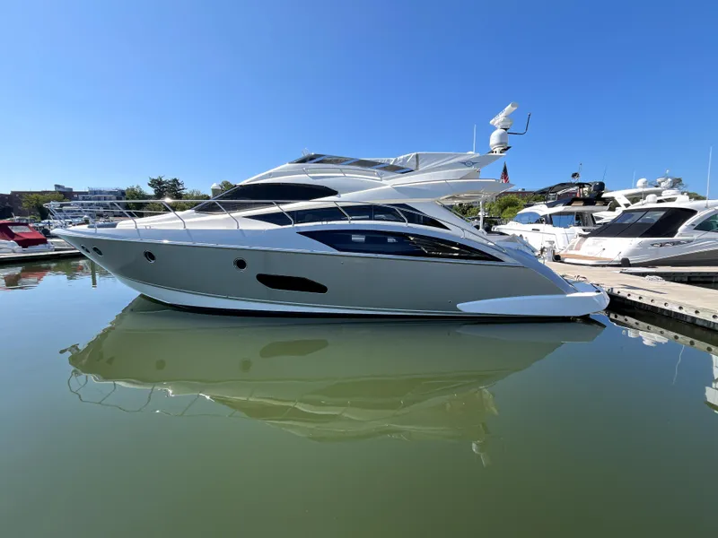 Slide: The Image of 2010 Marquis 500 Sport Bridge yacht docked in marina, reflecting on calm water. - 15