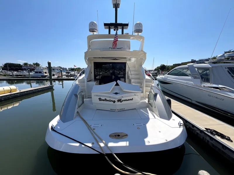 Slide: The Image of 2010 Marquis 500 Sport Bridge yacht docked at marina, rear view. - 16