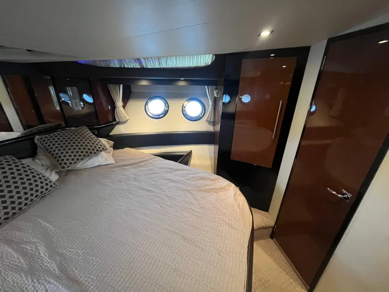 Slide: The Image of Luxurious bedroom interior of 2010 Marquis 500 Sport Bridge yacht with porthole windows. - 20