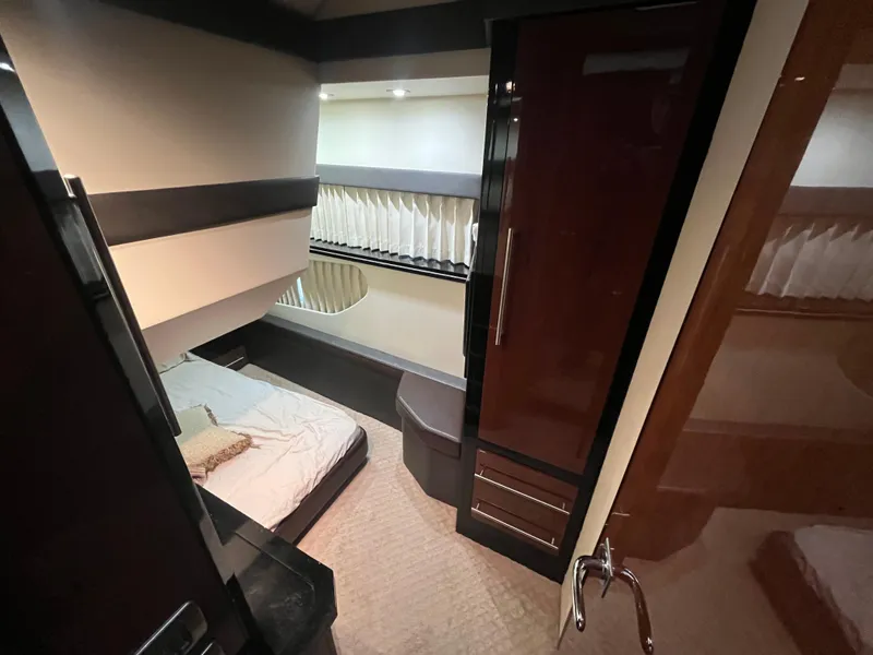 Slide: The Image of Interior cabin of 2010 Marquis 500 Sport Bridge yacht, featuring a cozy bed and modern design. - 22