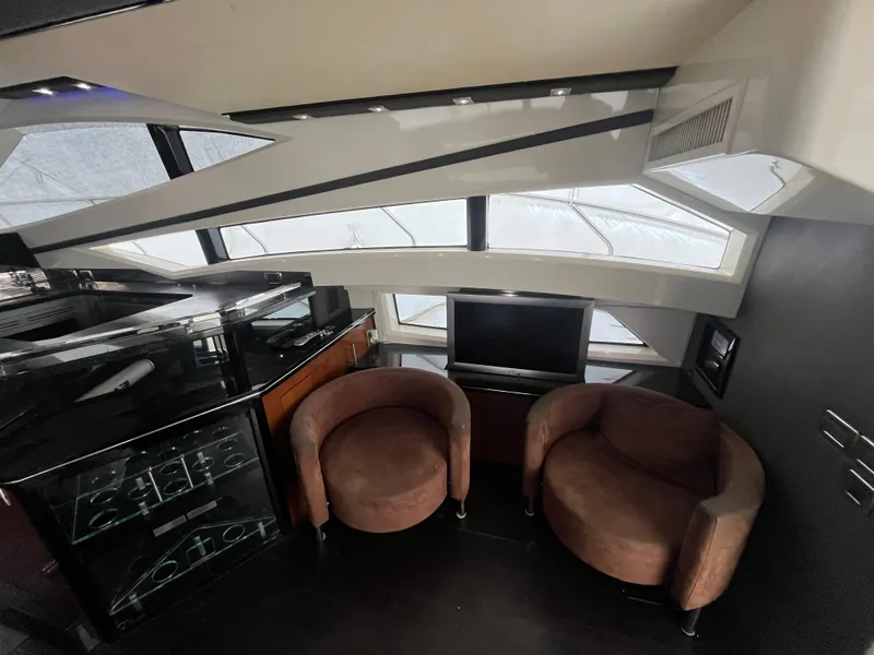 Slide: The Image of Interior of 2010 Marquis 500 Sport Bridge yacht with modern seating and sleek design. - 24