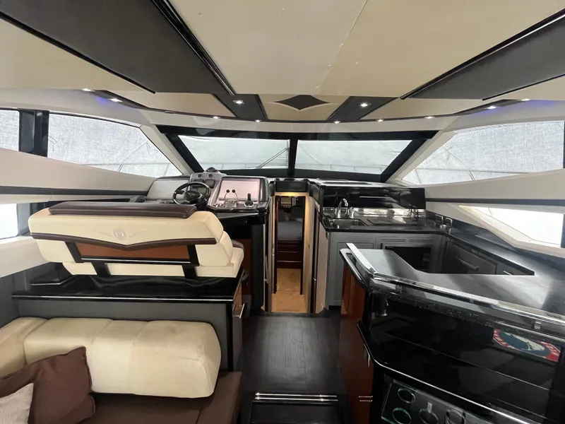 Slide: The Image of Luxurious interior of 2010 Marquis 500 Sport Bridge yacht with modern helm and seating. - 25