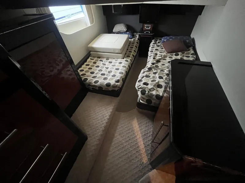 Slide: The Image of Interior cabin of 2010 Marquis 500 Sport Bridge yacht with twin beds and modern decor. - 27