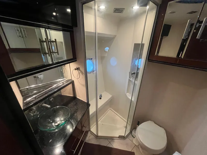 Slide: The Image of Luxurious bathroom in 2010 Marquis 500 Sport Bridge yacht with glass shower and modern fixtures. - 28