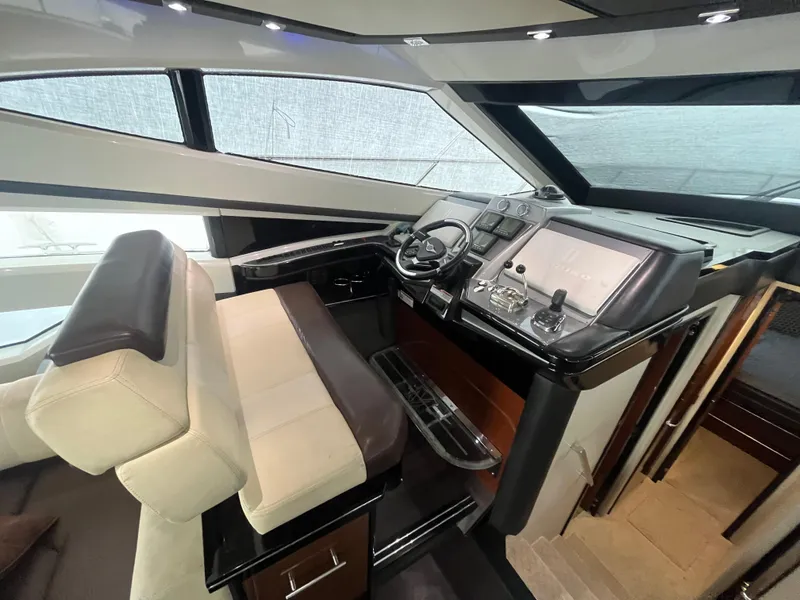 Slide: The Image of Interior helm of 2010 Marquis 500 Sport Bridge yacht, featuring modern controls and luxurious seating. - 29