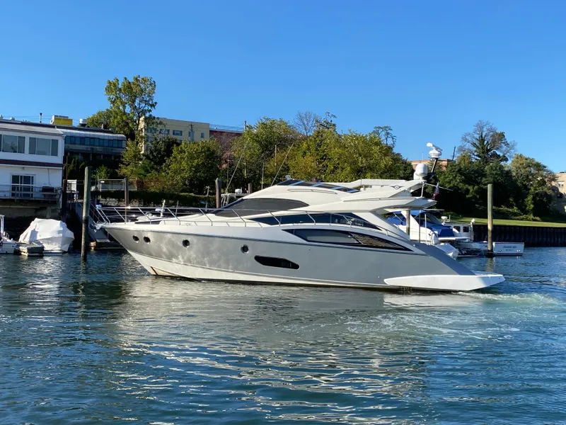 The Image of 2010 Marquis 500 Sport Bridge yacht on a sunny day in a marina. - 3
