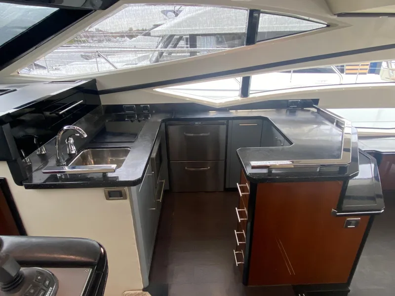 Slide: The Image of Luxurious kitchen area in a 2010 Marquis 500 Sport Bridge yacht with modern amenities. - 9