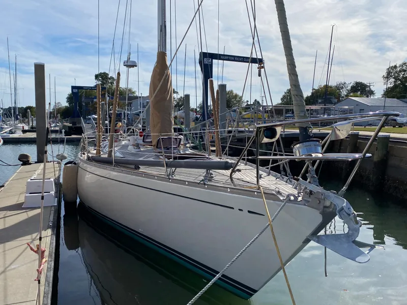 Slide: The Image of 1973 Nautor Swan 44 sailboat docked at a marina under a clear sky. - 10