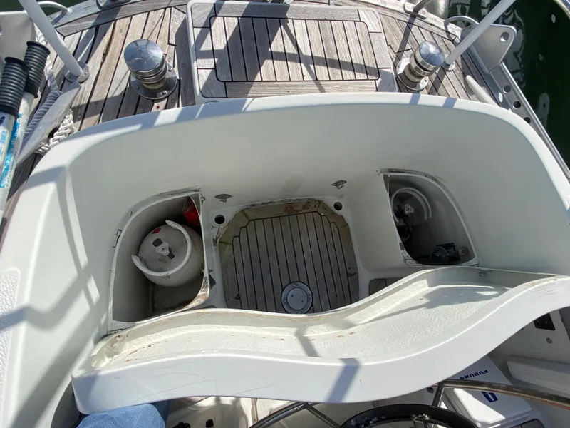 Slide: The Image of Cockpit of 1973 Nautor Swan 44 sailboat with wooden deck and storage compartments. - 15