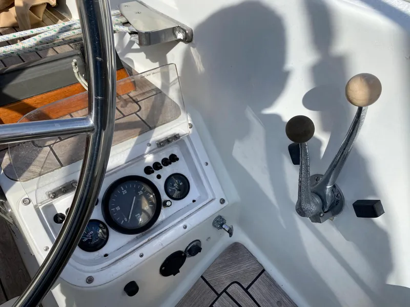 Slide: The Image of Cockpit controls of a 1973 Nautor Swan 44 sailboat, featuring steering wheel and instrument panel. - 18