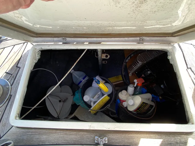 Slide: The Image of Storage compartment on a 1973 Nautor Swan 44 yacht, containing cleaning supplies and tools. - 21