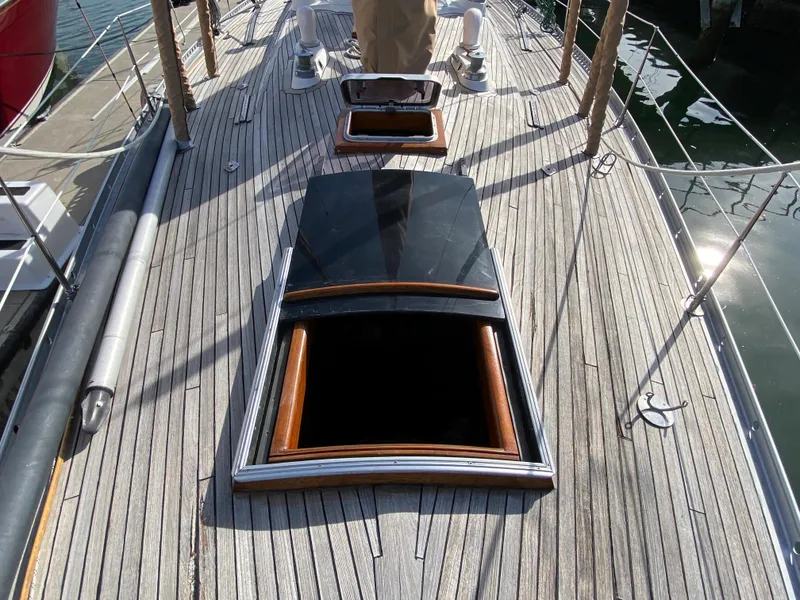 Slide: The Image of Deck of 1973 Nautor Swan 44 sailboat with open hatches and wooden details. - 23