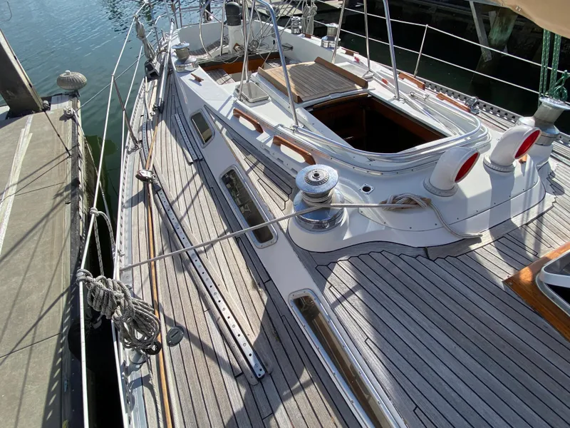 Slide: The Image of 1973 Nautor Swan 44 sailboat deck with wooden finish and open hatch. - 29