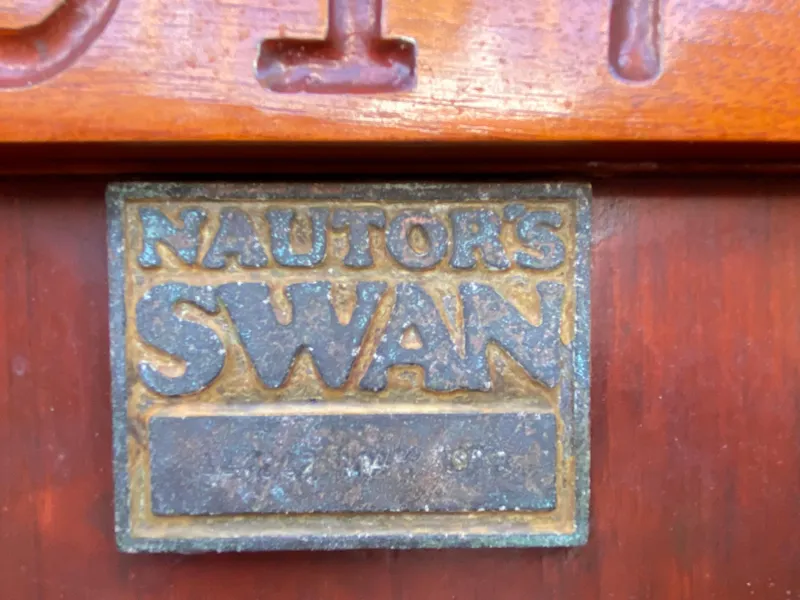 Slide: The Image of Plaque of Nautor Swan 44 yacht, 1973 model, on wooden surface. - 33