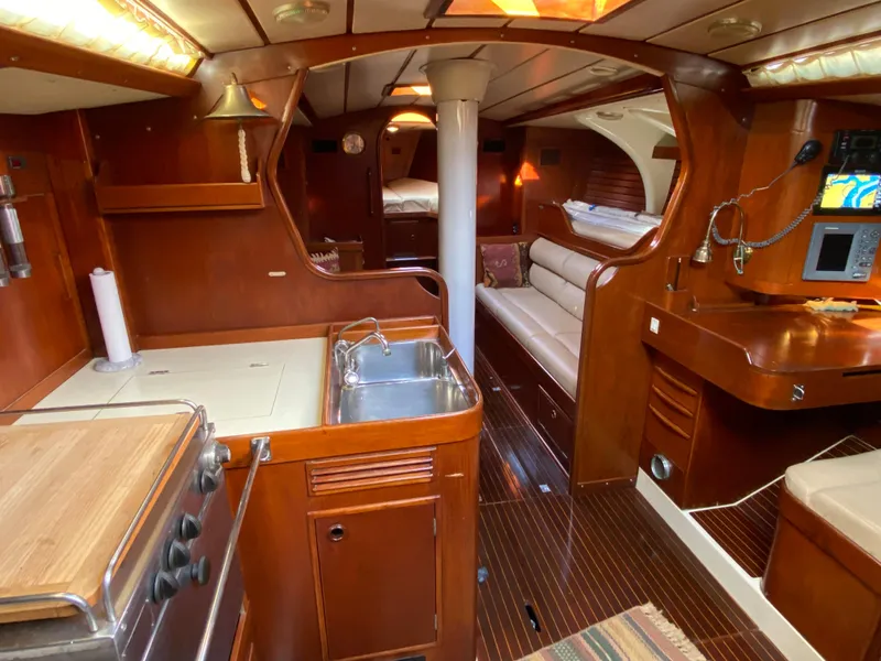 Slide: The Image of Interior of 1973 Nautor Swan 44 yacht with wooden finish and cozy seating area. - 36