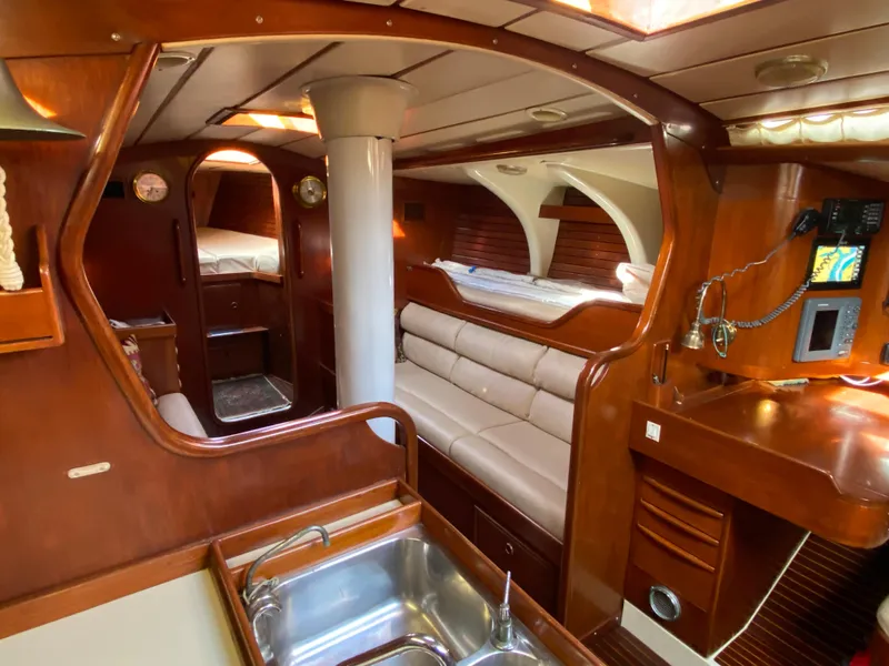 Slide: The Image of Interior of 1973 Nautor Swan 44 yacht with wooden finish and cozy seating area. - 38