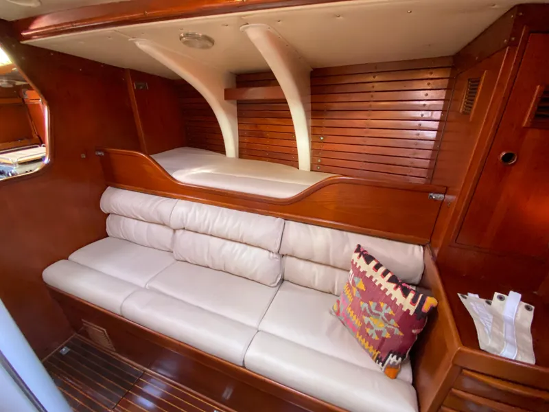 Slide: The Image of Interior of 1973 Nautor Swan 44 yacht with wooden paneling and white seating. - 39