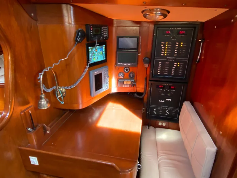 Slide: The Image of Navigation station of 1973 Nautor Swan 44 yacht with control panels and seating. - 40