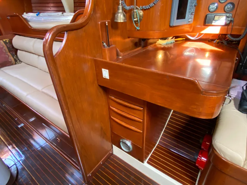 Slide: The Image of Interior of 1973 Nautor Swan 44 yacht with polished wood and navigation station. - 41