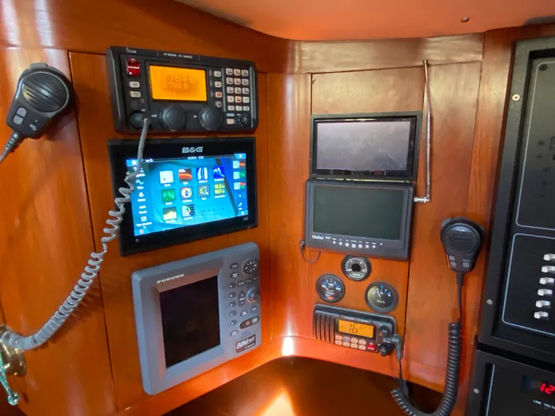 Slide: The Image of Navigation equipment on a 1973 Nautor Swan 44 yacht, featuring radios and display screens. - 42