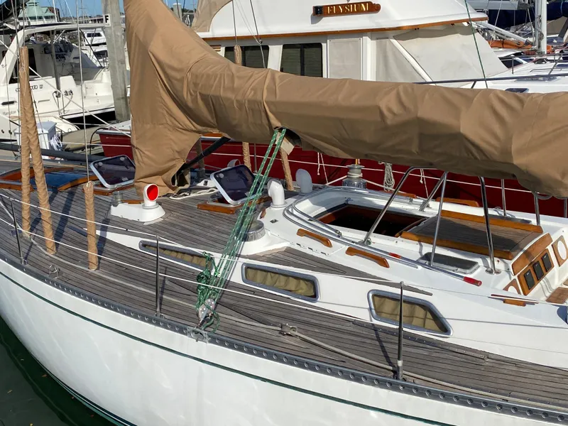 Slide: The Image of 1973 Nautor Swan 44 sailboat with covered mast, docked in a marina. - 5