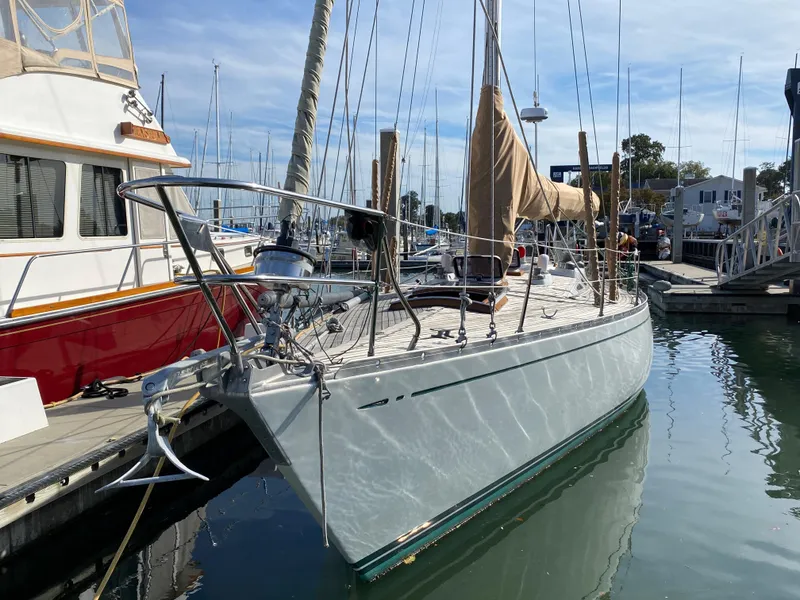 Slide: The Image of 1973 Nautor Swan 44 sailboat docked in marina, reflecting on calm water. - 6