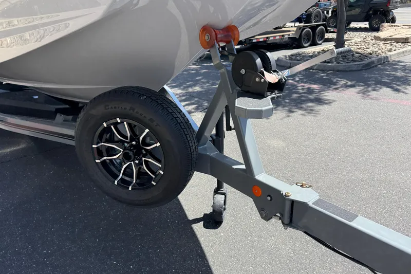 Slide: The Image of 2025 MasterCraft NXT24 boat trailer with black alloy wheel and winch system. - 20