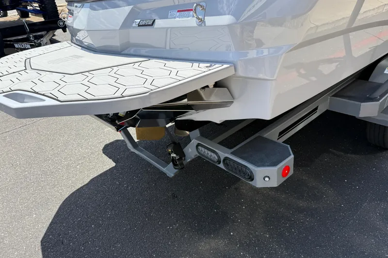 Slide: The Image of 2025 MasterCraft NXT24 boat rear view with swim platform and trailer. - 22