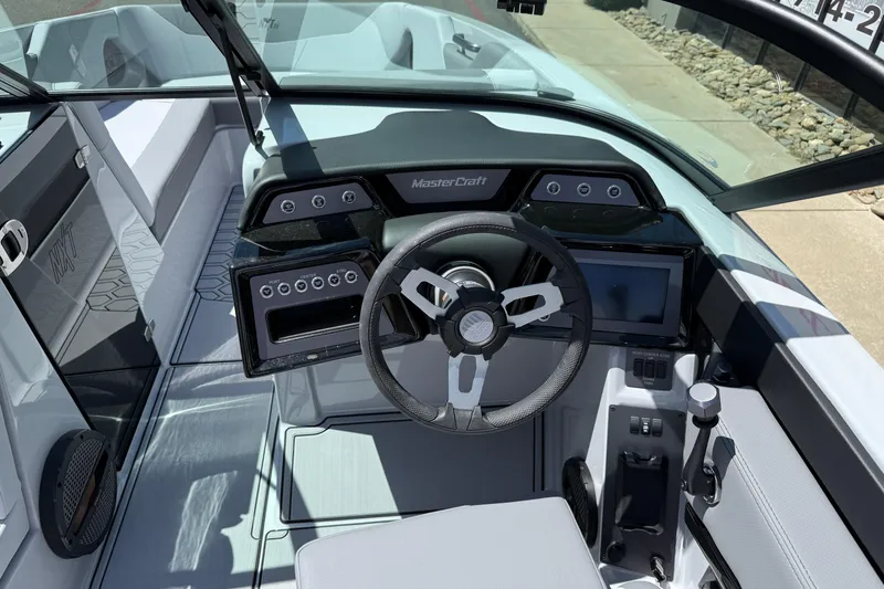 Slide: The Image of 2025 MasterCraft NXT24 boat interior with modern dashboard and steering wheel. - 25