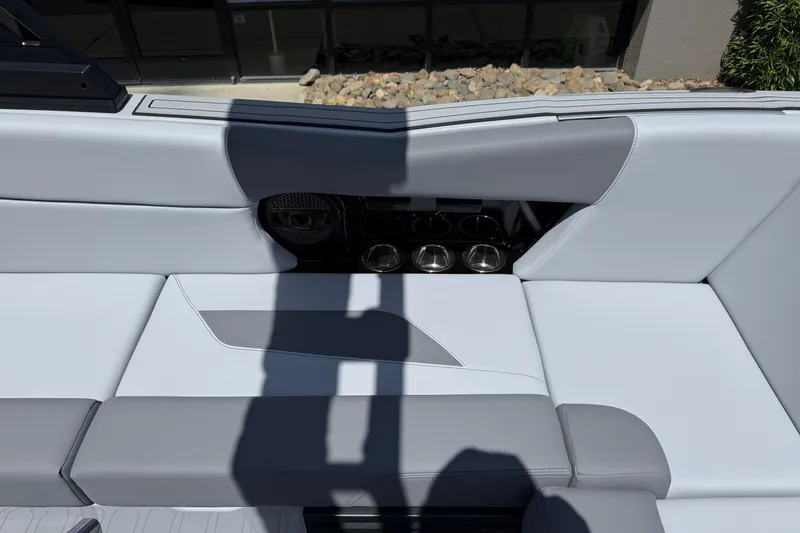 Slide: The Image of 2025 MasterCraft NXT24 boat interior with sleek seating and cup holders. - 28