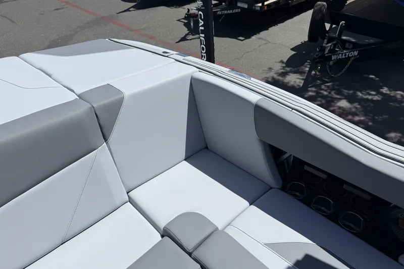 Slide: The Image of 2025 MasterCraft NXT24 boat interior with sleek gray and white seating design. - 31