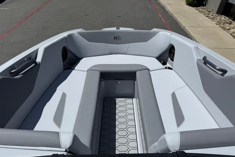 Slide: The Image of 2025 MasterCraft NXT24 boat interior with sleek gray seating and modern design. - 35