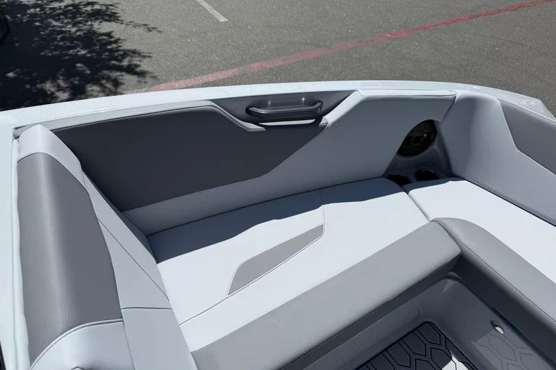 Slide: The Image of Interior seating of 2025 MasterCraft NXT24 boat, featuring sleek gray upholstery. - 36