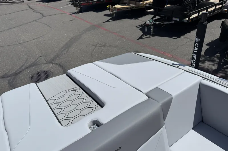 Slide: The Image of 2025 MasterCraft NXT24 boat interior with sleek gray seating and textured flooring. - 41