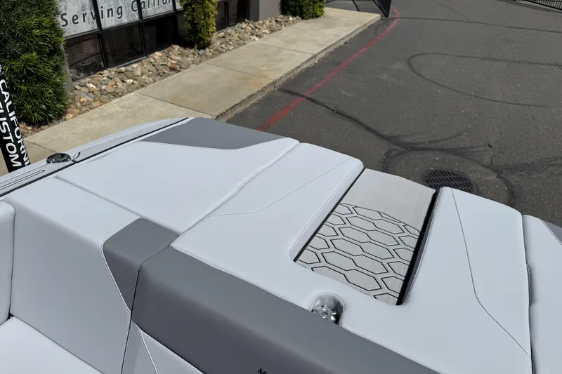 Slide: The Image of 2025 MasterCraft NXT24 boat with sleek gray seating and hexagonal pattern detail. - 42